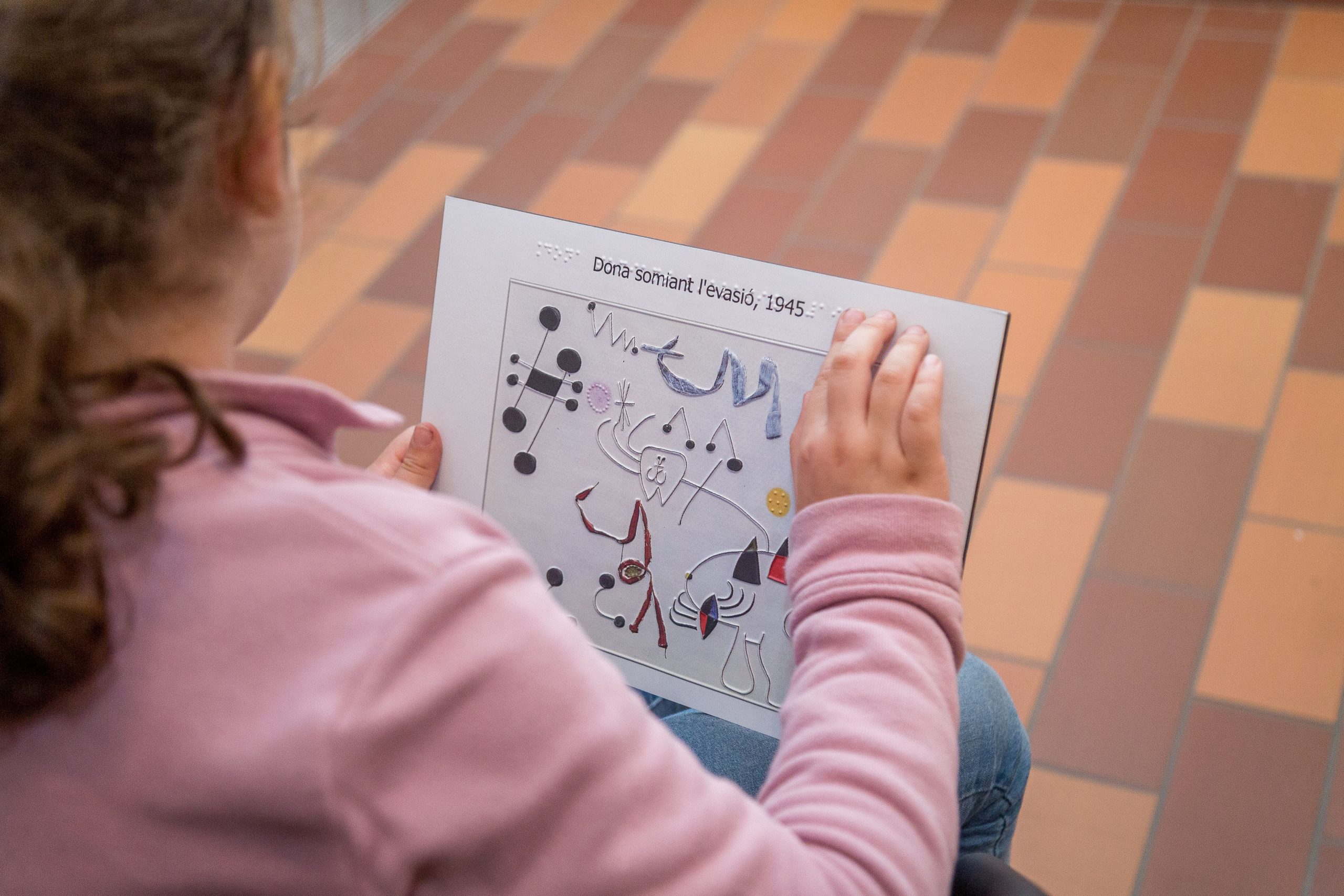 A child exploring a Miro’s raised image