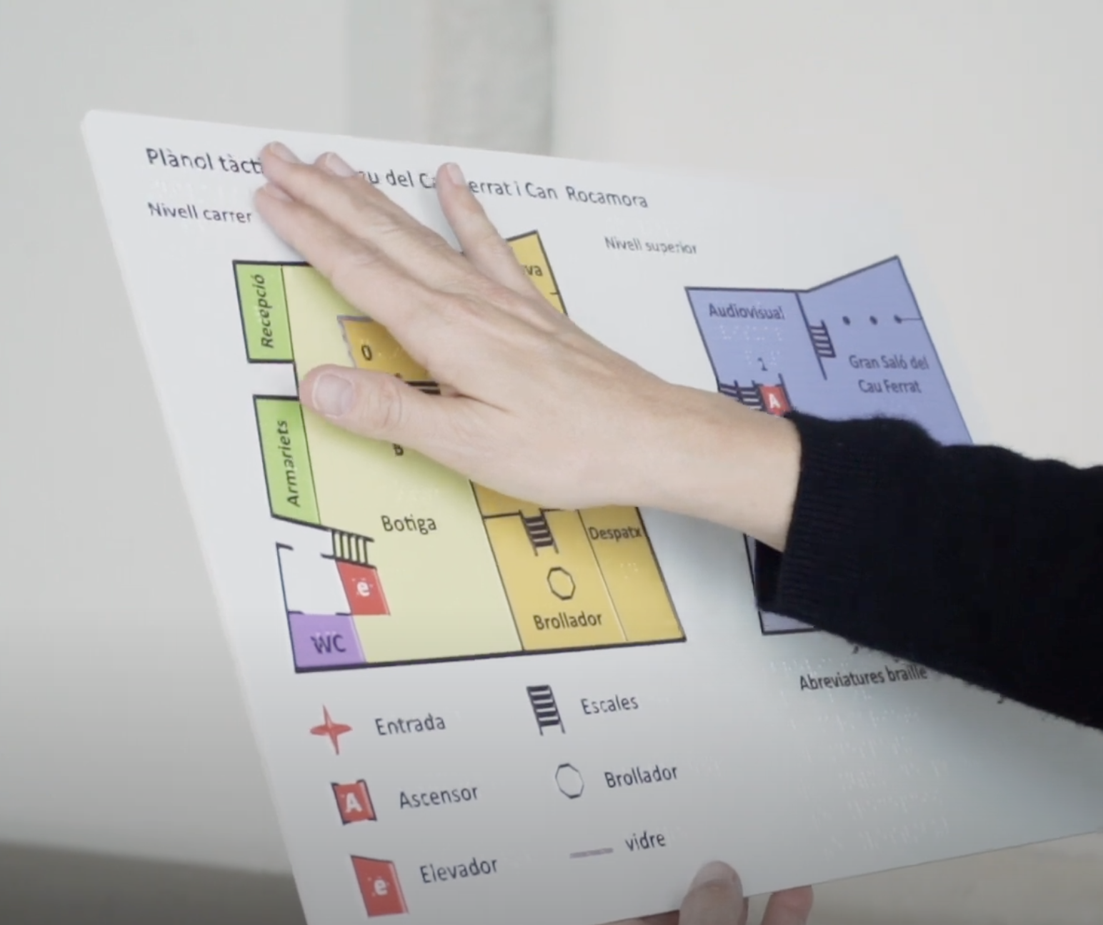 Close-up of a person exploring the inclusive tactile map of the Cau Ferrat Museum